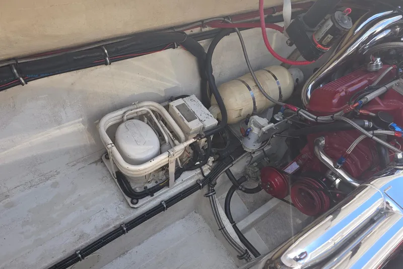 Slide: The Image of Engine compartment of a 1992 Fountain boat, featuring mechanical components and wiring. - 6