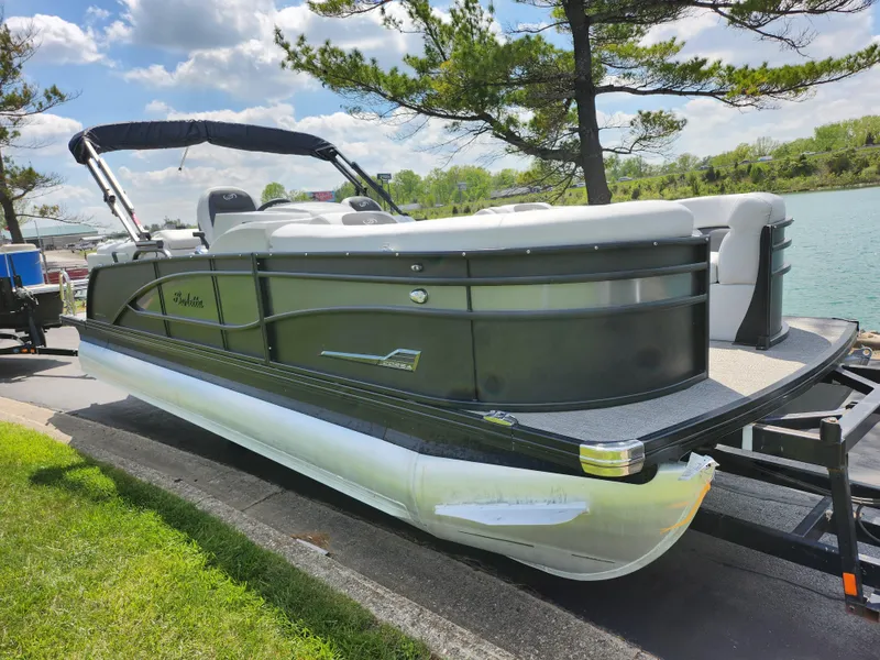 Slide: The Image of 2021 Barletta CORSA 23QC pontoon boat on trailer by a lake. - 8