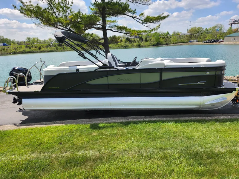 Slide: The Image of 2021 Barletta CORSA 23QC pontoon boat docked by a scenic lake. - 9