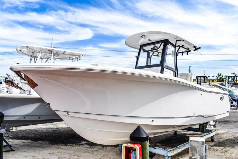Slide: The Image of 2026 Sea Hunt Gamefish 25 boat on display under a clear blue sky. - 1