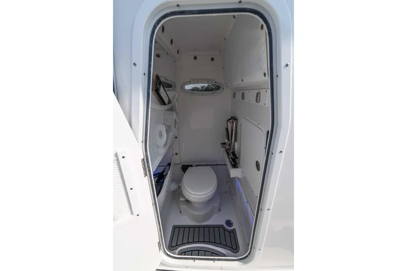 Slide: The Image of Interior of 2026 Sea Hunt Gamefish 25 boat's compact bathroom with toilet. - 12
