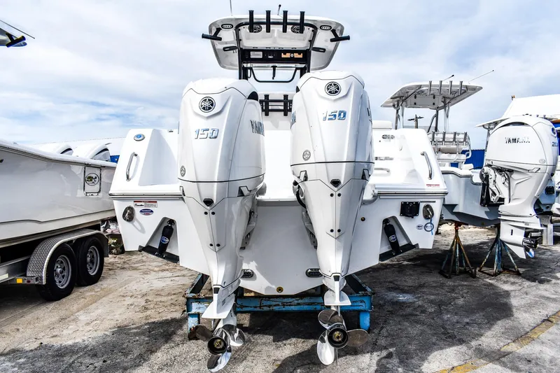 Slide: The Image of 2026 Sea Hunt Gamefish 25 with dual Yamaha 150 engines, displayed on a trailer. - 2