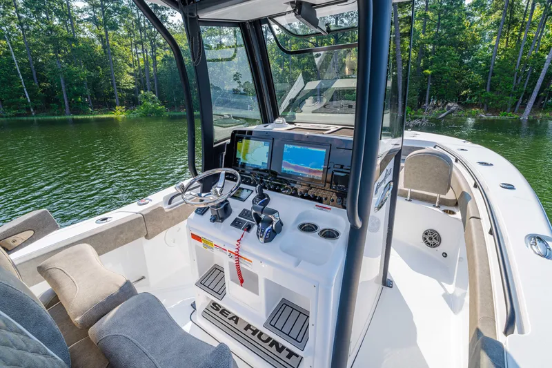 Slide: The Image of 2026 Sea Hunt Gamefish 25 boat interior with advanced navigation system and comfortable seating. - 9