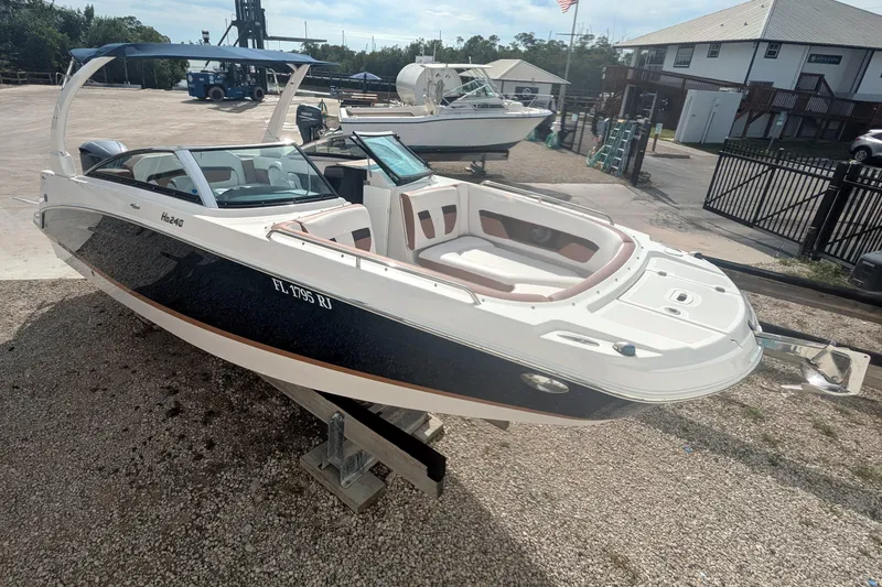 Slide: The Image of 2017 Four Winns HD240 OB boat on display at a marina, featuring sleek design. - 0