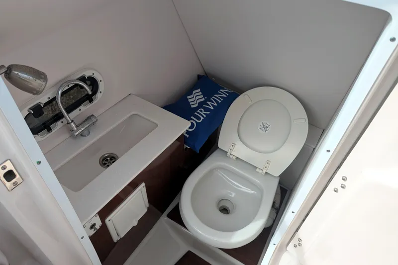 Slide: The Image of 2017 Four Winns HD240 OB boat bathroom with sink and toilet. - 11