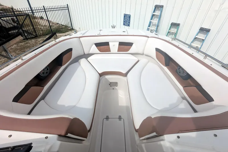 Slide: The Image of 2017 Four Winns HD240 OB boat interior with white and brown seating. - 13