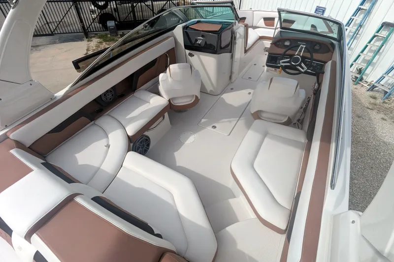 Slide: The Image of 2017 Four Winns HD240 OB boat interior with white and brown seating, steering console, and open layout. - 15