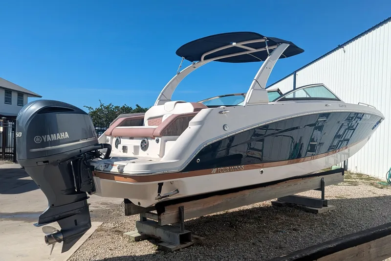Slide: The Image of 2017 Four Winns HD240 OB boat with Yamaha outboard motor, docked outdoors. - 6