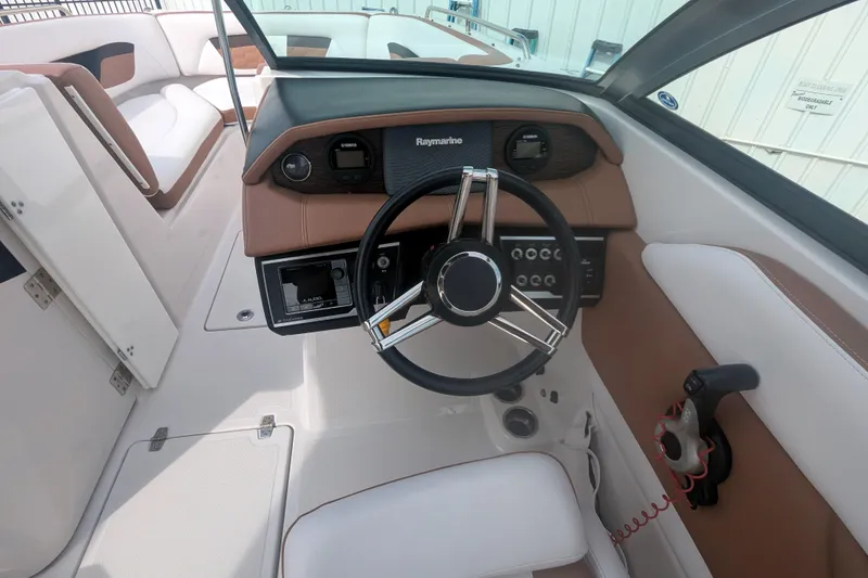 Slide: The Image of 2017 Four Winns HD240 OB boat interior with steering wheel and dashboard controls. - 8