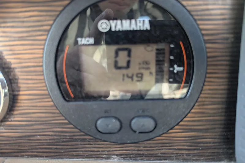 Slide: The Image of Yamaha tachometer on 2017 Four Winns HD240 OB boat dashboard, displaying 149 hours. - 9