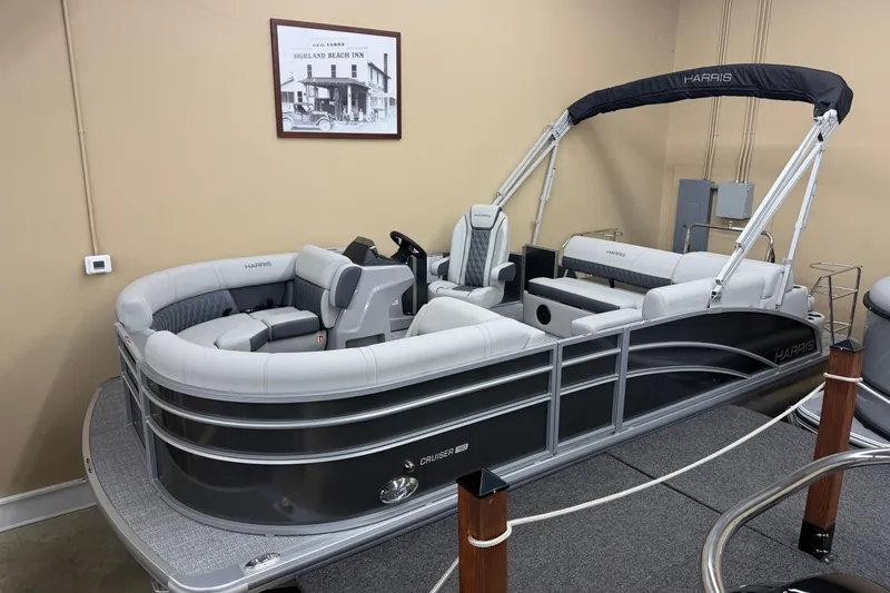 The Image of 2026 Harris Cruiser 190 pontoon boat in showroom, featuring sleek design and comfortable seating. - 1