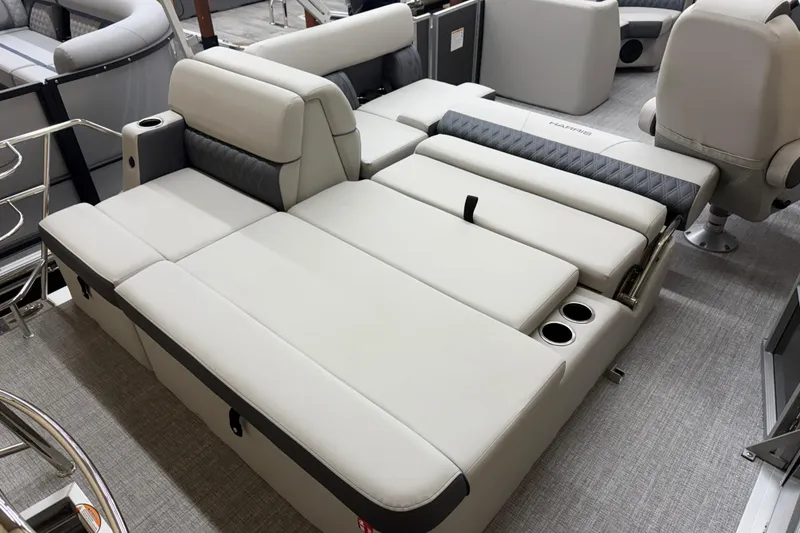 Slide: The Image of Luxurious seating on 2026 Harris Cruiser 190 pontoon boat, featuring plush upholstery and cup holders. - 11