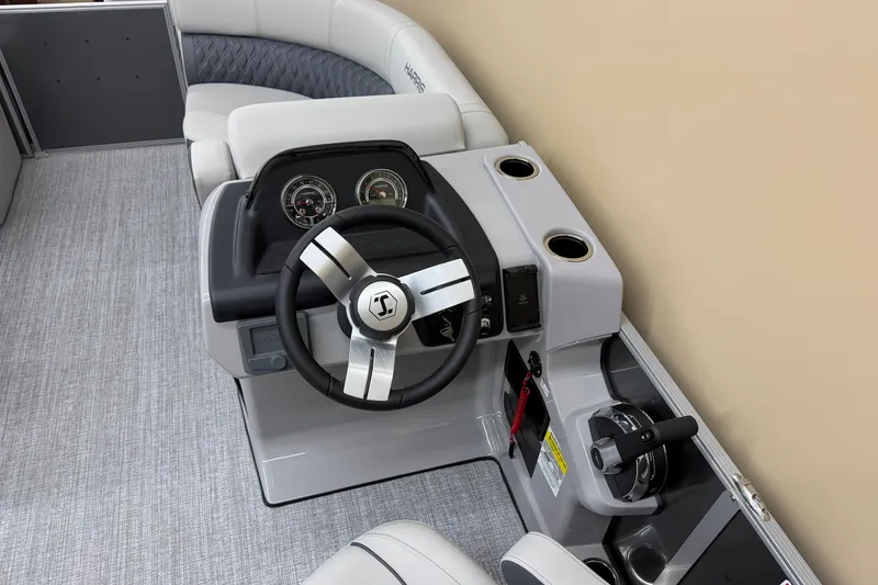 Slide: The Image of 2026 Harris Cruiser 190 boat helm with steering wheel and control panel. - 6