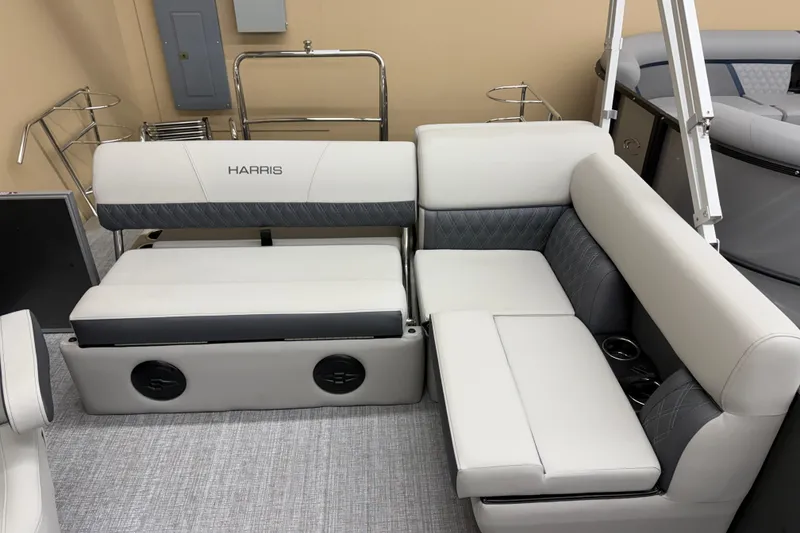 Slide: The Image of 2026 Harris Cruiser 190 boat interior with white and gray seating, cup holders, and storage. - 8