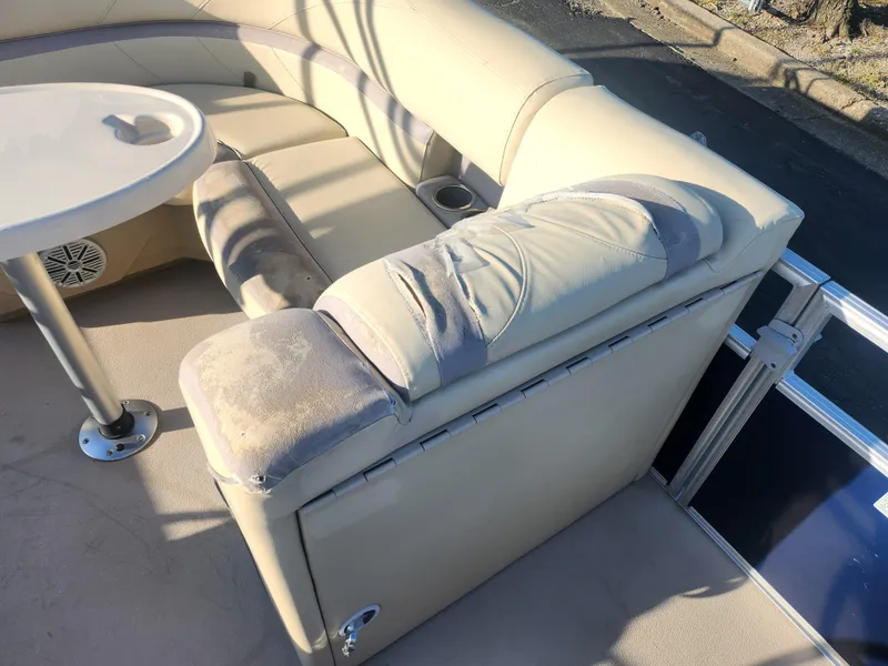 Slide: The Image of 2018 SunChaser Geneva Cruise 22 DLX 4.0 Fish boat interior with beige seating and table. - 13