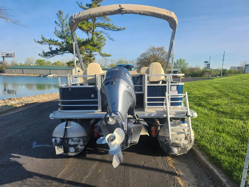 Slide: The Image of 2018 SunChaser Geneva Cruise 22 DLX 4.0 Fish pontoon boat by a lake. - 2