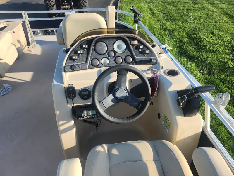 Slide: The Image of 2018 SunChaser Geneva Cruise 22 DLX 4.0 Fish boat dashboard with steering wheel and controls. - 22