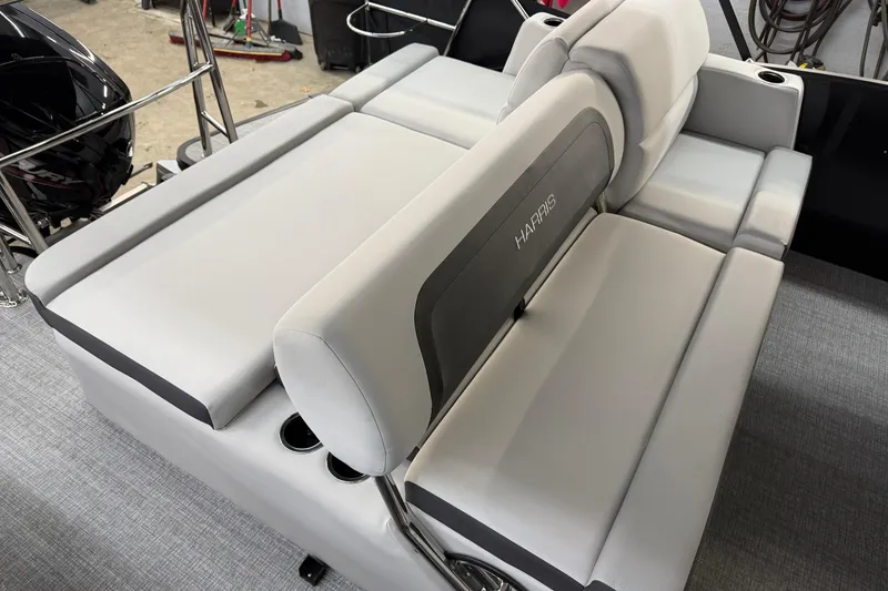 Slide: The Image of 2026 Harris Cruiser 210 boat interior with plush seating and cup holders. - 10