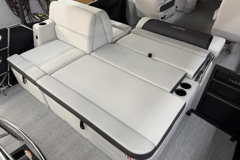 Slide: The Image of 2026 Harris Cruiser 210 boat interior with white cushioned seating and cup holders. - 12