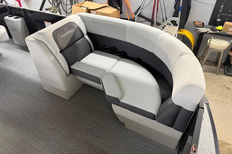 Slide: The Image of 2026 Harris Cruiser 210 boat seating with gray upholstery in a workshop setting. - 3