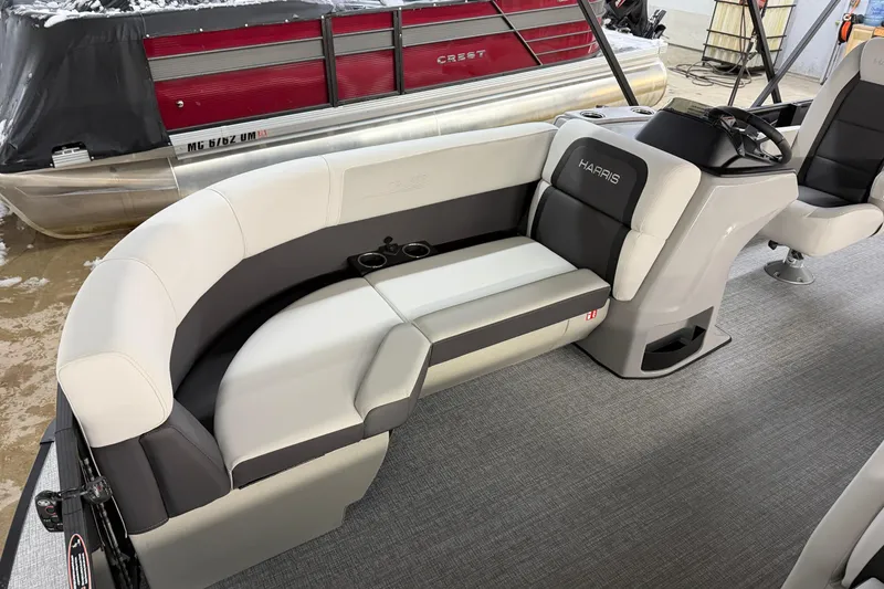 Slide: The Image of 2026 Harris Cruiser 210 pontoon boat interior with plush seating and steering console. - 4