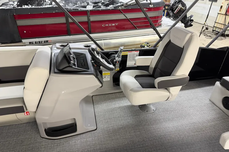 Slide: The Image of 2026 Harris Cruiser 210 boat interior with captain's chair and steering console. - 5