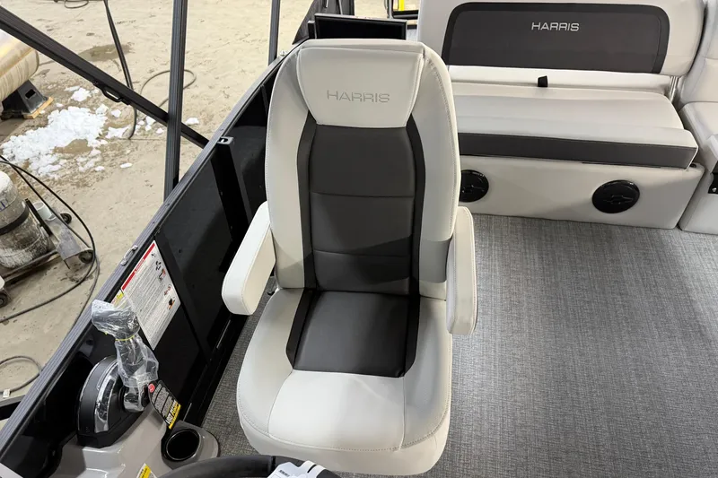 Slide: The Image of 2026 Harris Cruiser 210 boat interior with captain's chair and seating area. - 6