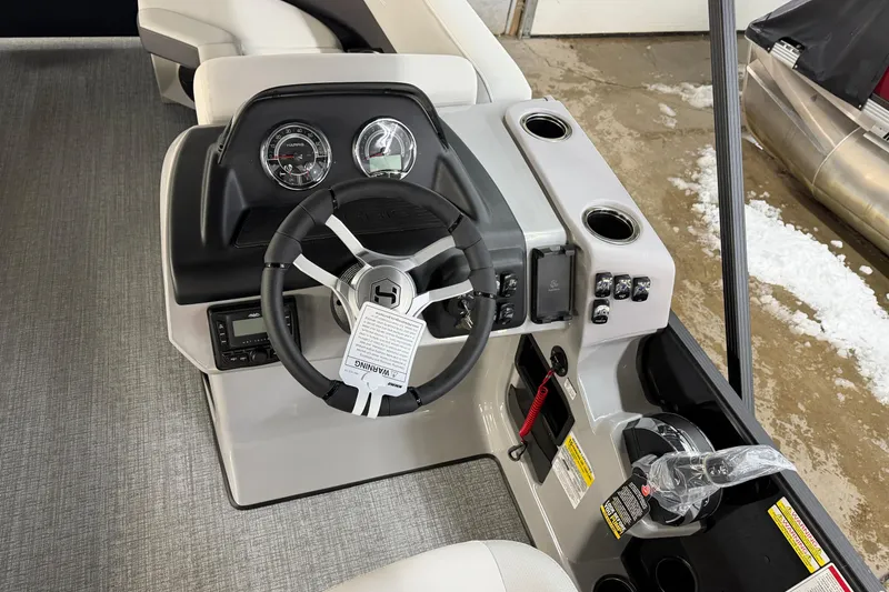 Slide: The Image of 2026 Harris Cruiser 210 boat dashboard with steering wheel and control panel. - 7