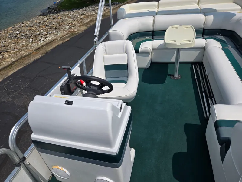 Slide: The Image of 2000 Odyssey Pontoons 2505 Millennium interior with seating and steering wheel. - 13