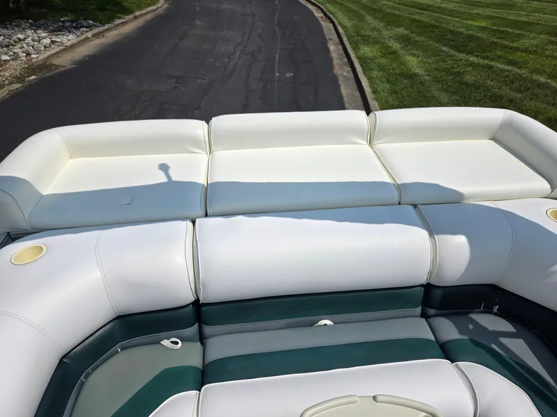Slide: The Image of 2000 Odyssey Pontoons 2505 Millennium boat with white and green seating on a sunny day. - 16