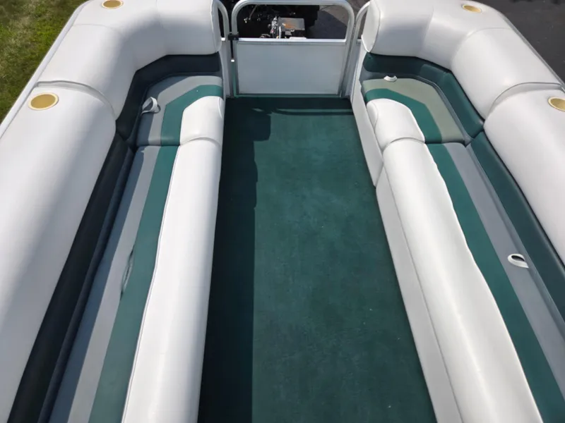 Slide: The Image of Interior of 2000 Odyssey Pontoons 2505 Millennium with green carpet and white seating. - 25