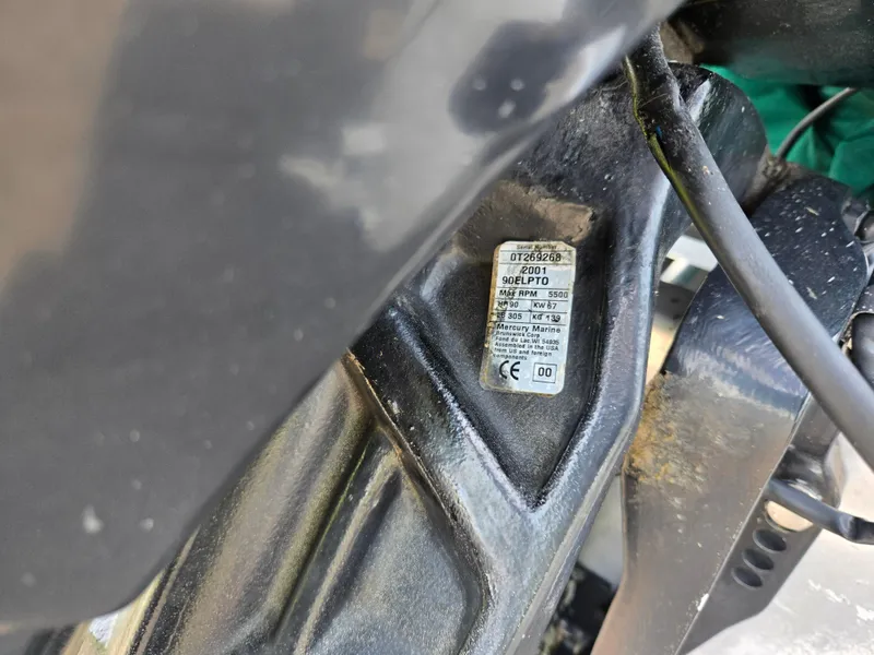 Slide: The Image of Close-up of a 2000 Odyssey Pontoons 2505 Millennium engine component with a label. - 27