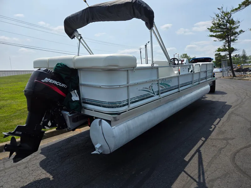 Slide: The Image of 2000 Odyssey Pontoons 2505 Millennium on road, featuring Mercury outboard motor. - 3