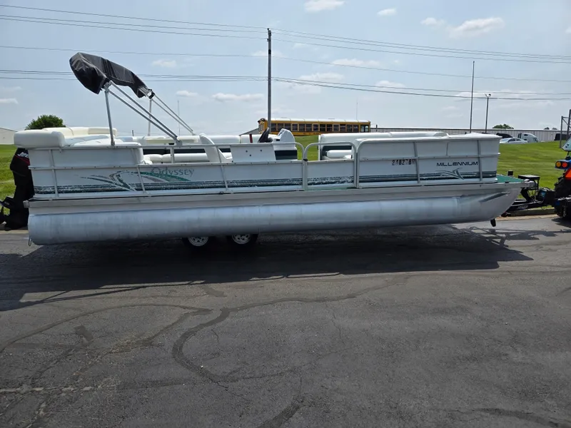 Slide: The Image of 2000 Odyssey Pontoons 2505 Millennium pontoon boat on a trailer, parked outdoors. - 4