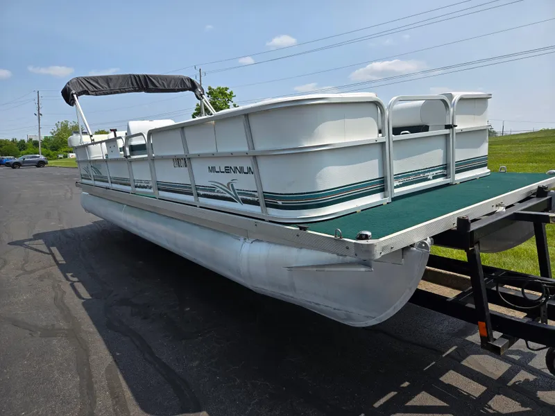 Slide: The Image of 2000 Odyssey Pontoons 2505 Millennium boat on trailer, parked outdoors. - 5