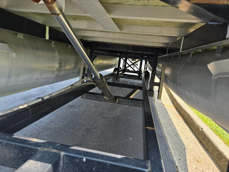 Slide: The Image of Underside view of a 2000 Odyssey Pontoons 2505 Millennium boat on a trailer. - 7