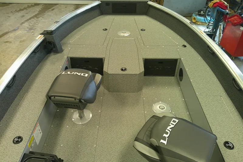 Slide: The Image of 2026 Lund 1700 Explorer Tiller boat interior with seating and storage compartments. - 5