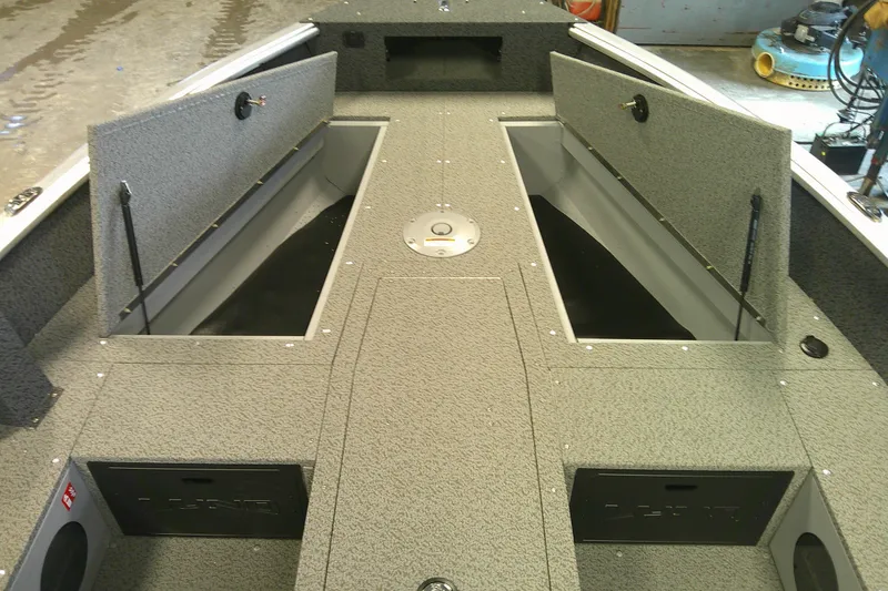 Slide: The Image of 2026 Lund 1700 Explorer Tiller boat interior with open storage compartments. - 6