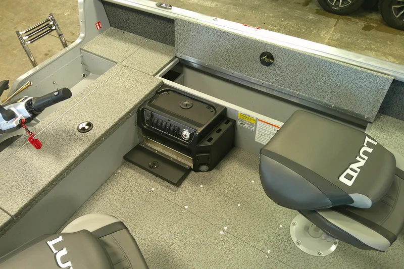 Slide: The Image of 2026 Lund 1700 Explorer Tiller boat interior with seating and control panel. - 9