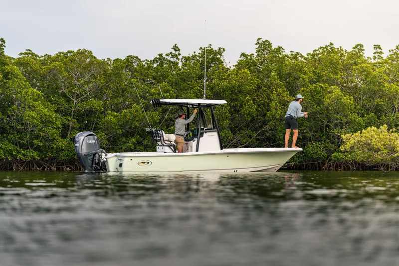 Slide: The Image of 2026 Sea Hunt BX 22 BR boat with anglers fishing near lush mangroves. - 10