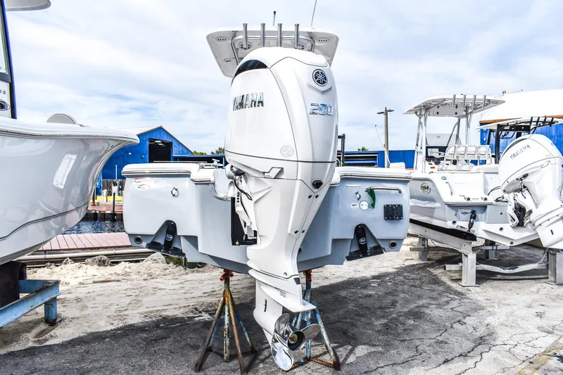 Slide: The Image of 2026 Sea Hunt BX 22 BR boat with Yamaha outboard motor, dockside view. - 2