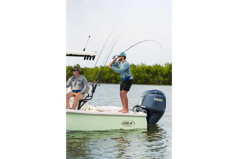 Slide: The Image of Two people fishing on a 2026 Sea Hunt BX 22 BR boat with Yamaha engine. - 5