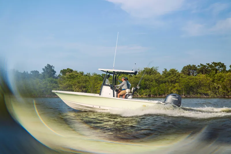 Slide: The Image of 2026 Sea Hunt BX 22 BR boat cruising on a scenic waterway. - 7