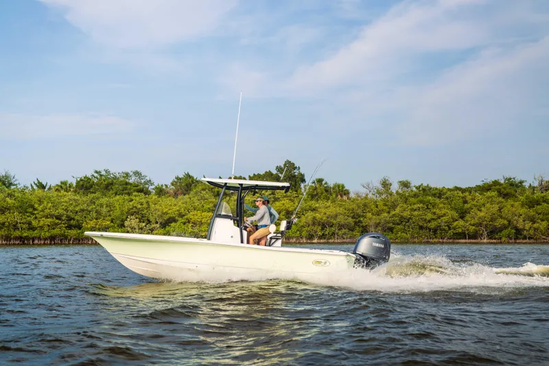 Slide: The Image of 2026 Sea Hunt BX 22 BR boat cruising on a scenic waterway. - 8