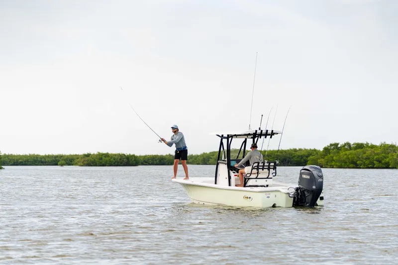 Slide: The Image of Two people fishing on a 2026 Sea Hunt BX 22 BR boat in calm waters. - 9