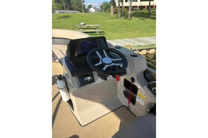 Slide: The Image of Steering console of 2024 Harris HCX23 boat with modern controls and fire extinguisher. - 3