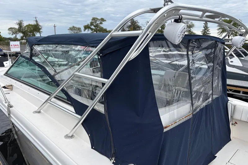 Slide: The Image of 1994 Sea Ray 310 Amberjack boat with blue canopy and stainless steel frame. - 19