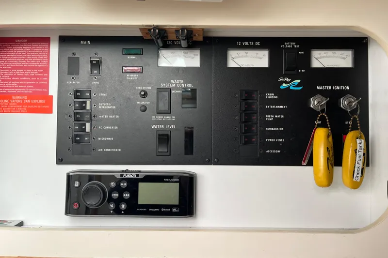 Slide: The Image of Control panel of a 1994 Sea Ray 310 Amberjack boat with ignition keys and warning labels. - 22