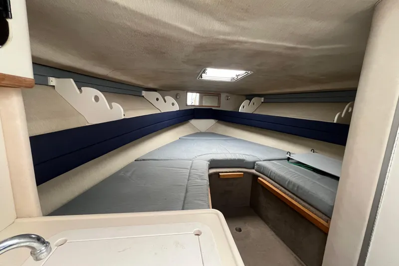 Slide: The Image of Interior cabin of 1994 Sea Ray 310 Amberjack, featuring cozy sleeping area and compact design. - 26