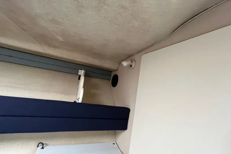 Slide: The Image of Interior view of a 1994 Sea Ray 310 Amberjack boat cabin ceiling and wall. - 30